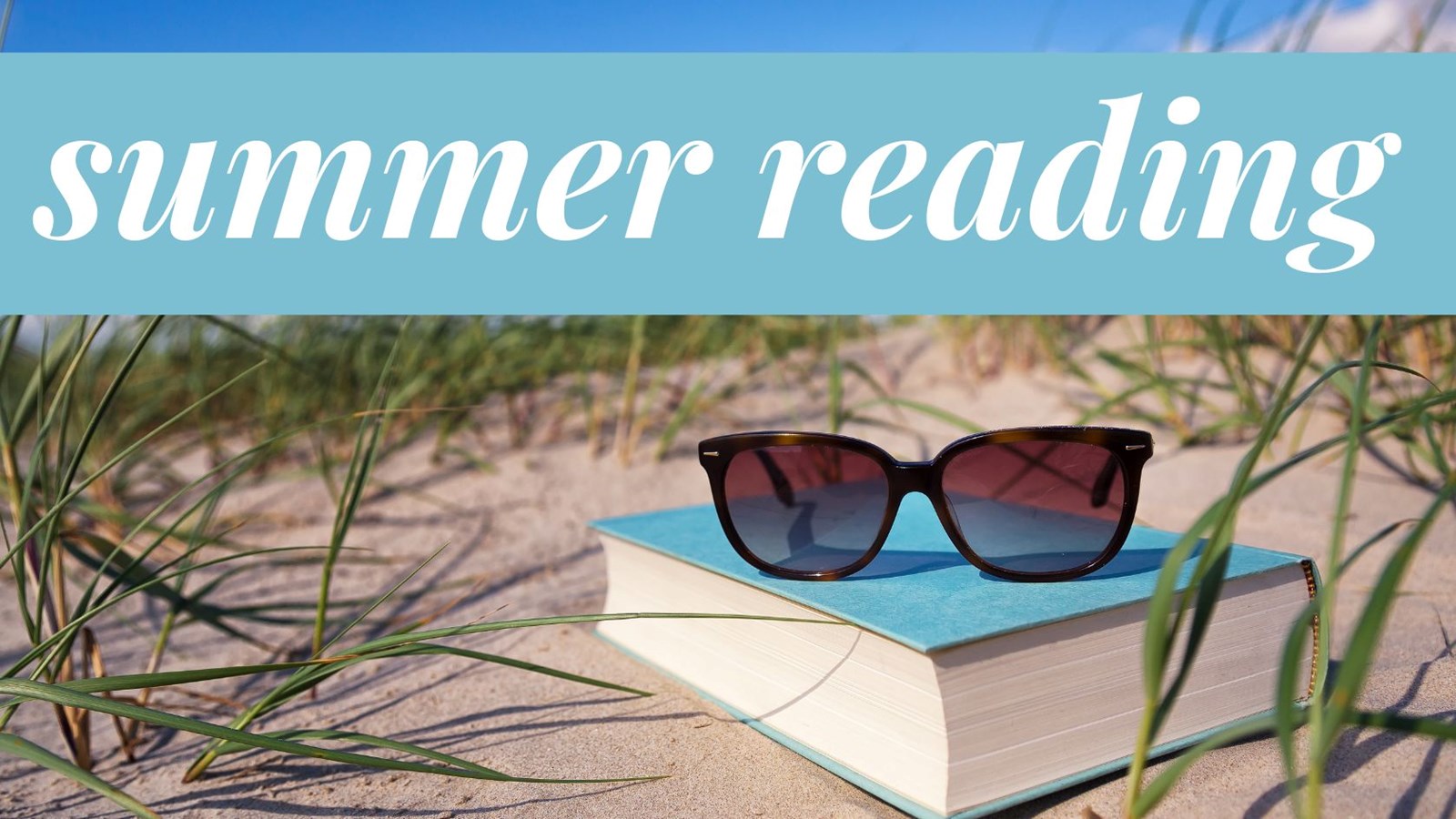 Summer Reading banner: Picture of a book on the beach with sunglasses on top of the book